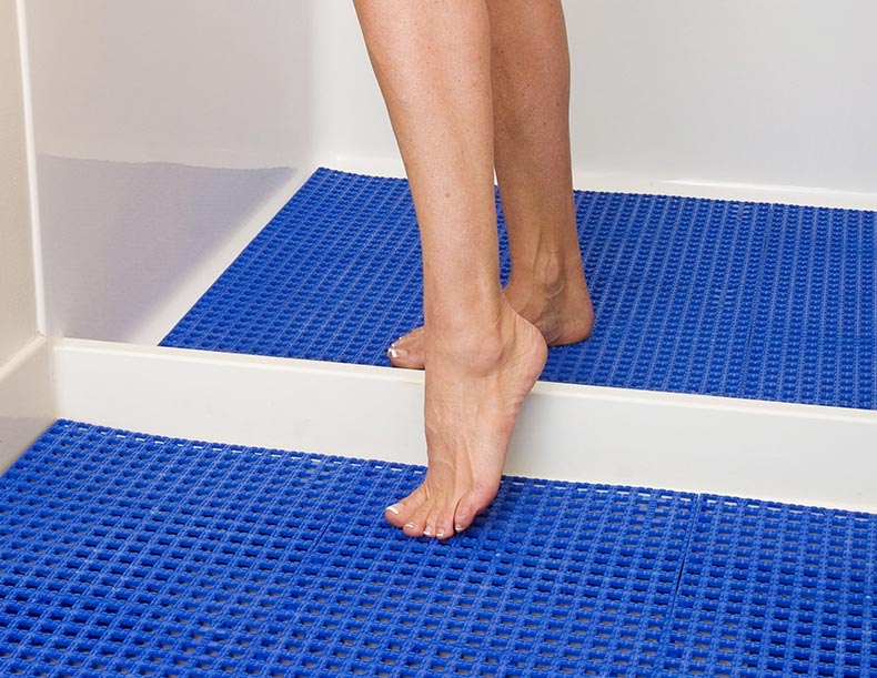 Shower mats used by woman getting out of the shower, indoor flooring